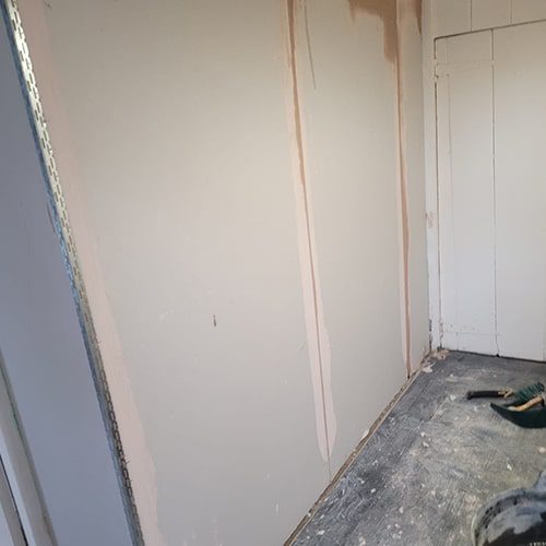 Plasterboard adhered to the affected walls