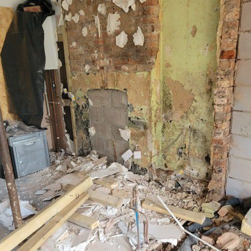 Removing the plaster back to brickwork