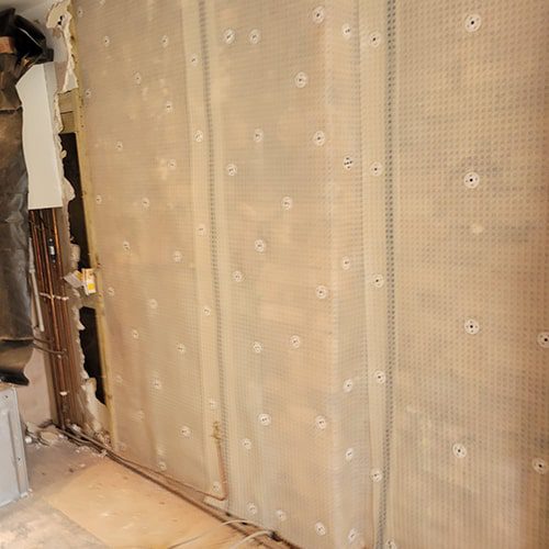 Waterproof membrane attached to the wall